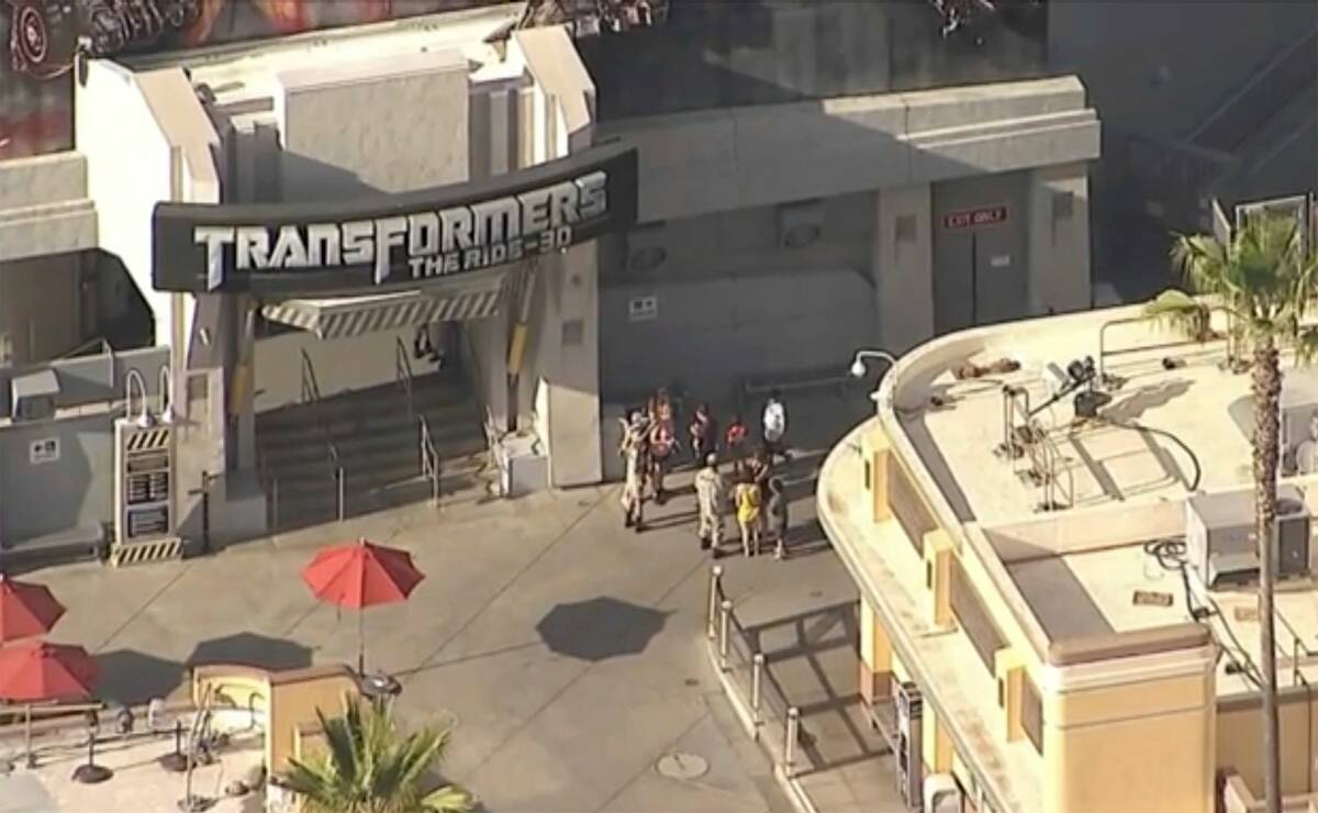 People stand near the Transformers ride at Universal Studios Hollywood in Los Angeles on Thursd ...