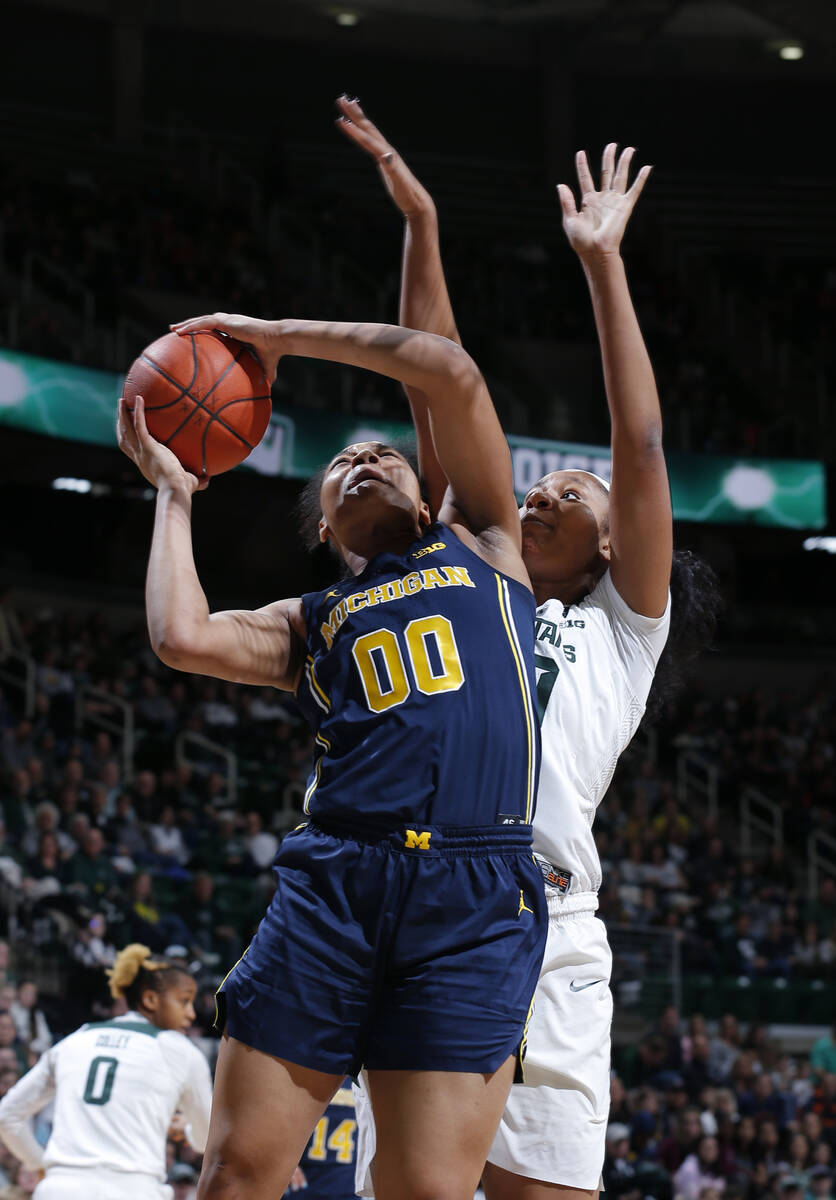 Michigan's Naz Hillman, left, shoots against Michigan State's Sidney Cooks during the first qua ...