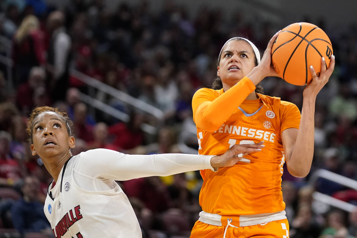 Tennessee's Rae Burrell, right, heads to the basket as Louisville's Kianna Smith defends during ...