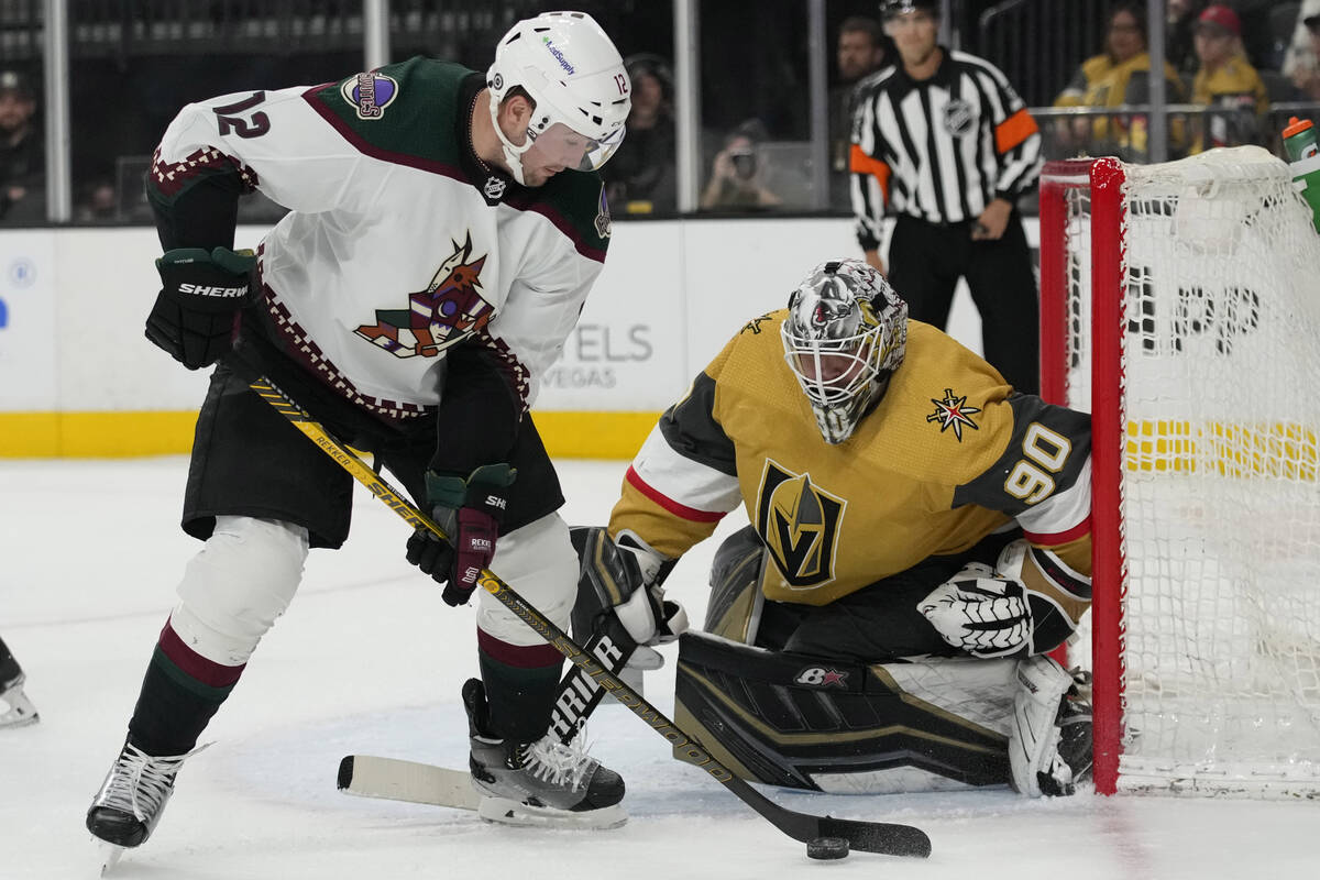 Arizona Coyotes left wing Nick Ritchie (12) attempts a shot on Vegas Golden Knights goaltender ...