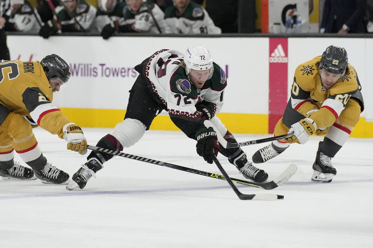 Arizona Coyotes center Travis Boyd (72) vies for the puck with Vegas Golden Knights' Mattias Ja ...