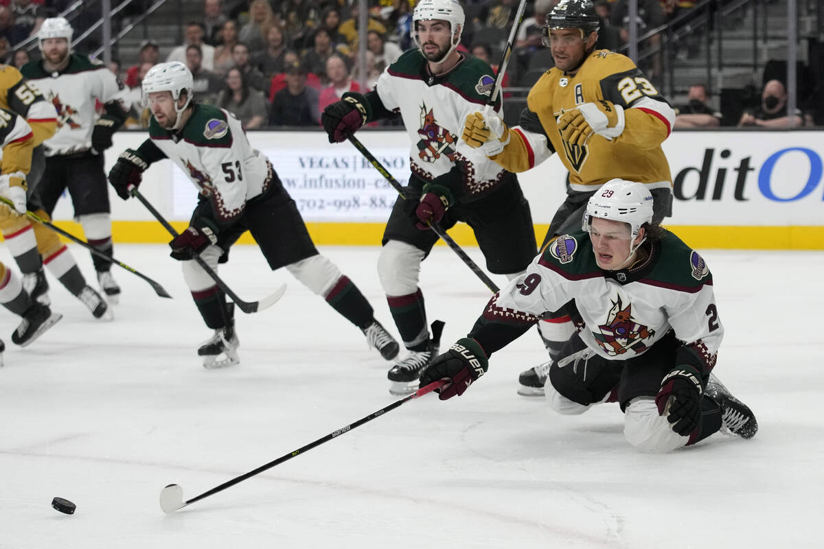 Arizona Coyotes center Barrett Hayton (29) knocks the puck up the ice against the Vegas Golden ...