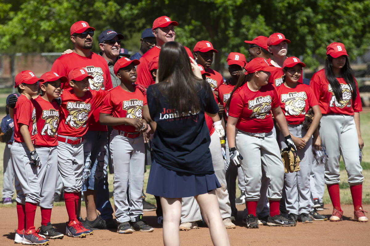 Sheriff Joe Lombardo poses with the Bulldogs before throwing the first pitch at Bolden Little L ...
