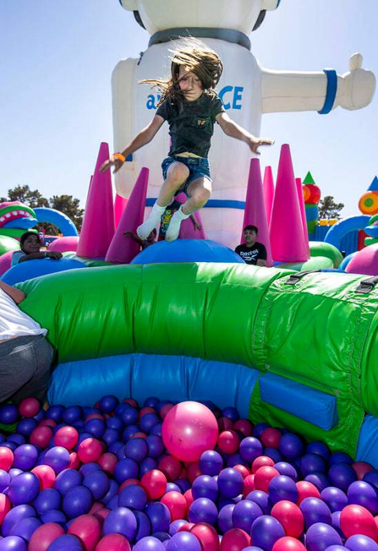 London Caseman, 9, of Las Vegas leaps into a ball pit in the Air Space Spaceman attraction at t ...