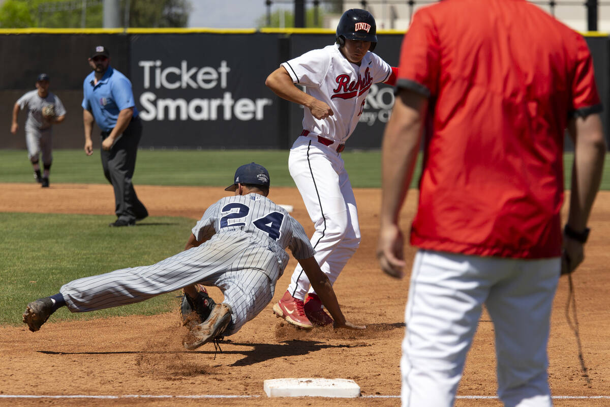 UNR first baseman Landon Wallace (24) attempts to out UNLV outfielder Rylan Charles (25) during ...