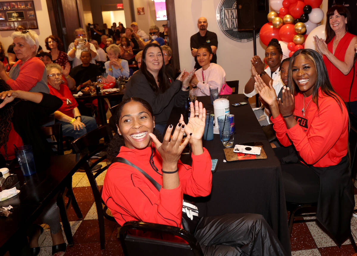 Aces players, including guard Sydney Colson, left, and center Kalani Brown cheer the Acesȁ ...
