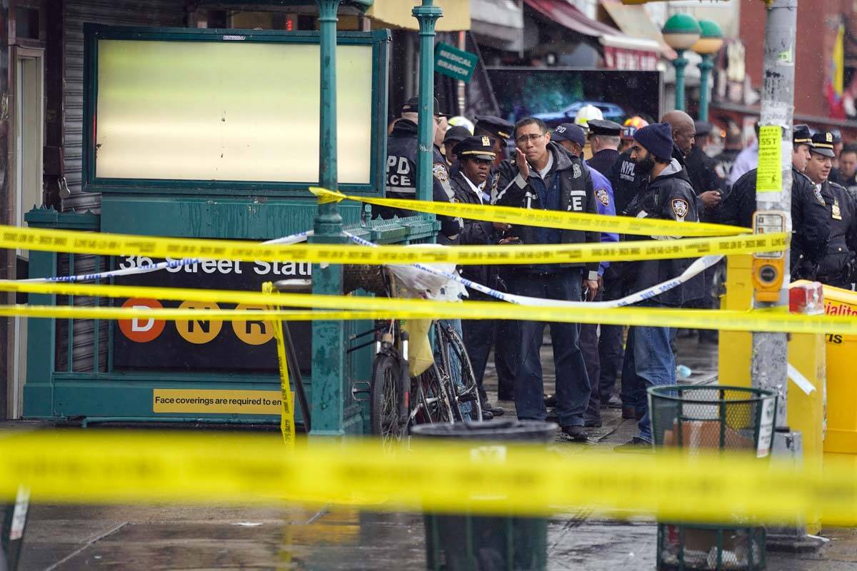 New York City Police Department personnel gather at the entrance to a subway stop in the Brookl ...