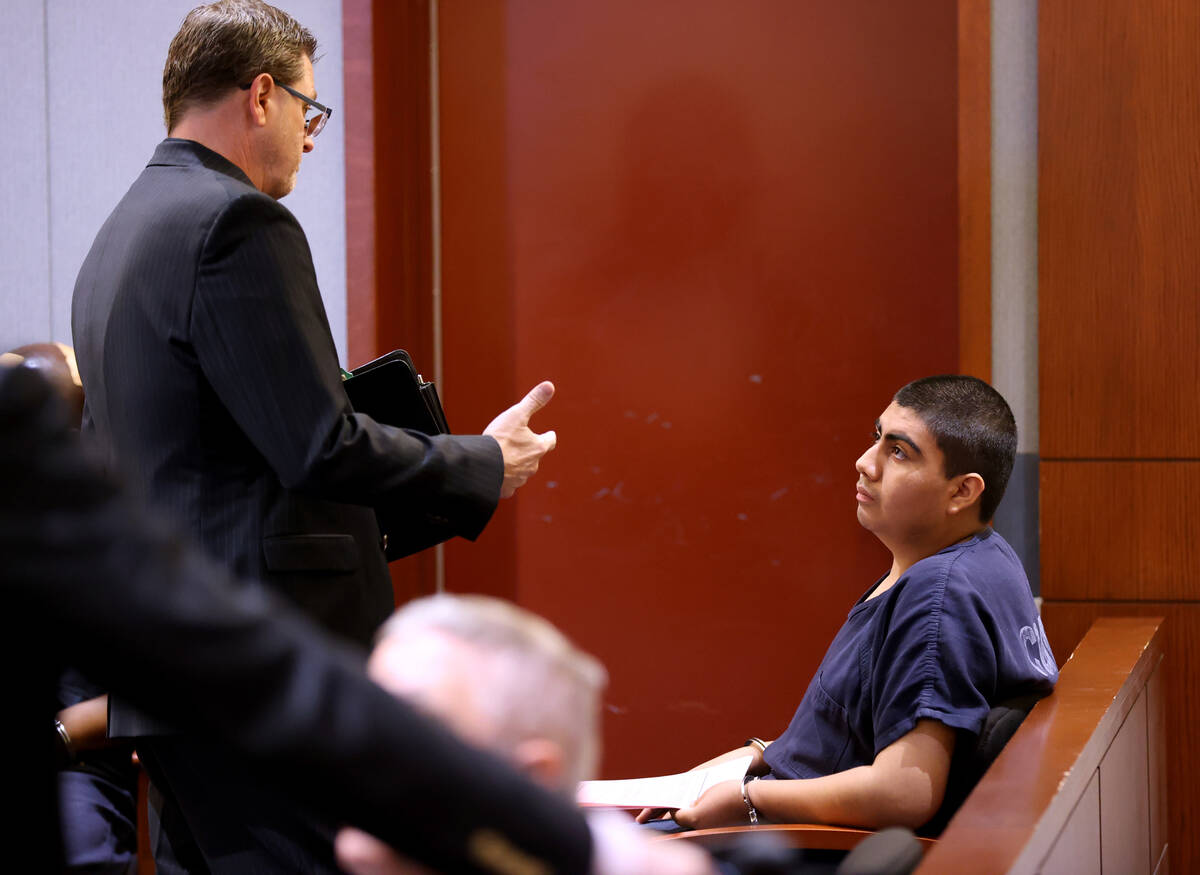 Jonathan Eluterio Martinez Garcia, right, talks to his attorney, Paul Adras, while waiting in c ...
