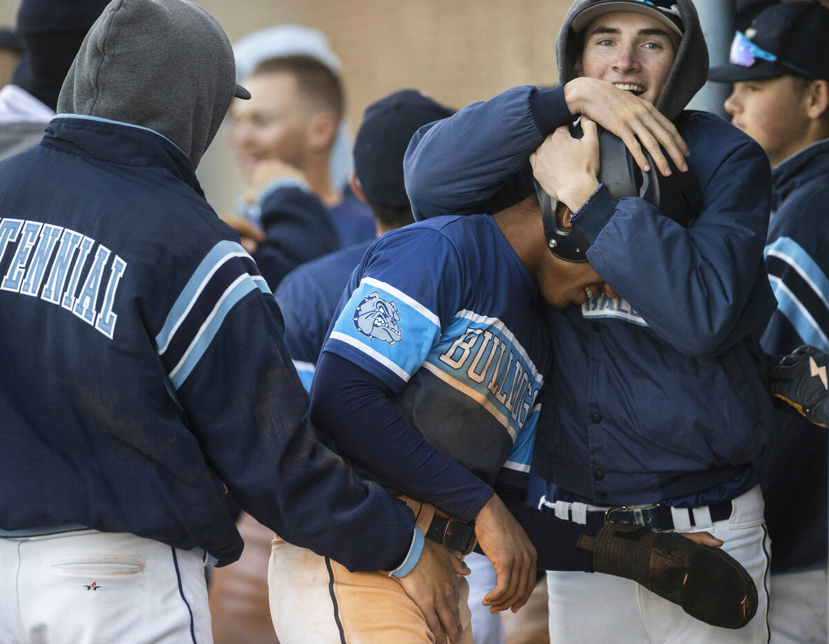 Centennial teammates celebrate with Alex Rhynes (6) after Rhynes scored during a boys high scho ...