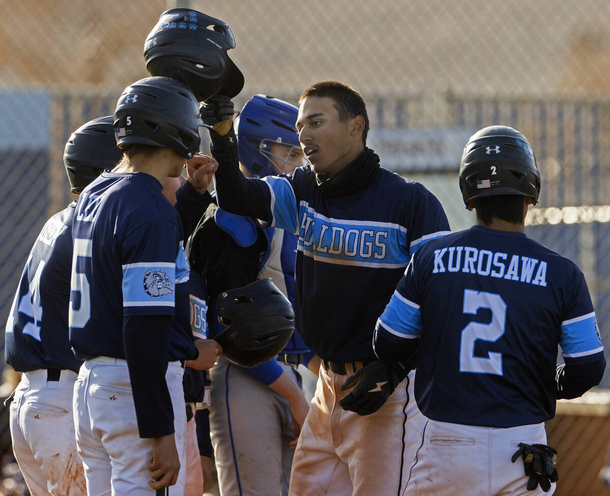 Centennial’s Joel Calderin (7) celebrates with teammates after hitting a home run durin ...
