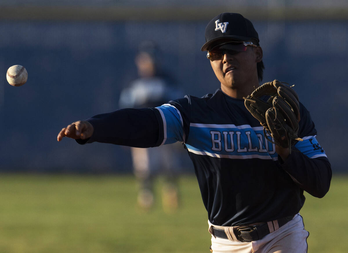 Centennial’s Rick Kurosawa (2) throws out a runner during a boys high school baseball ga ...