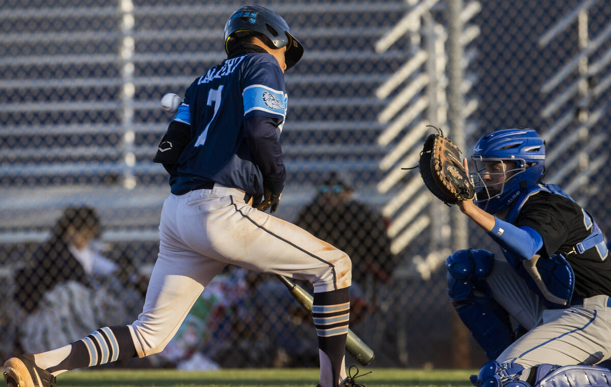 Centennial’s Joel Calderin (7) is hit by a pitch during a boys high school baseball game ...