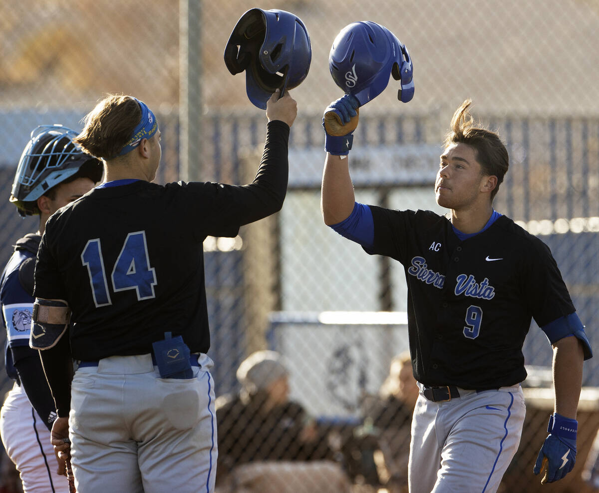 Sierra Vista’s J.T. Starkus (9) celebrates with teammate Mikey Clark (14) after hitting ...