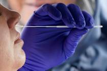 Salt Lake County Health Department public health nurse Lee Cherie Booth performs a coronavirus ...