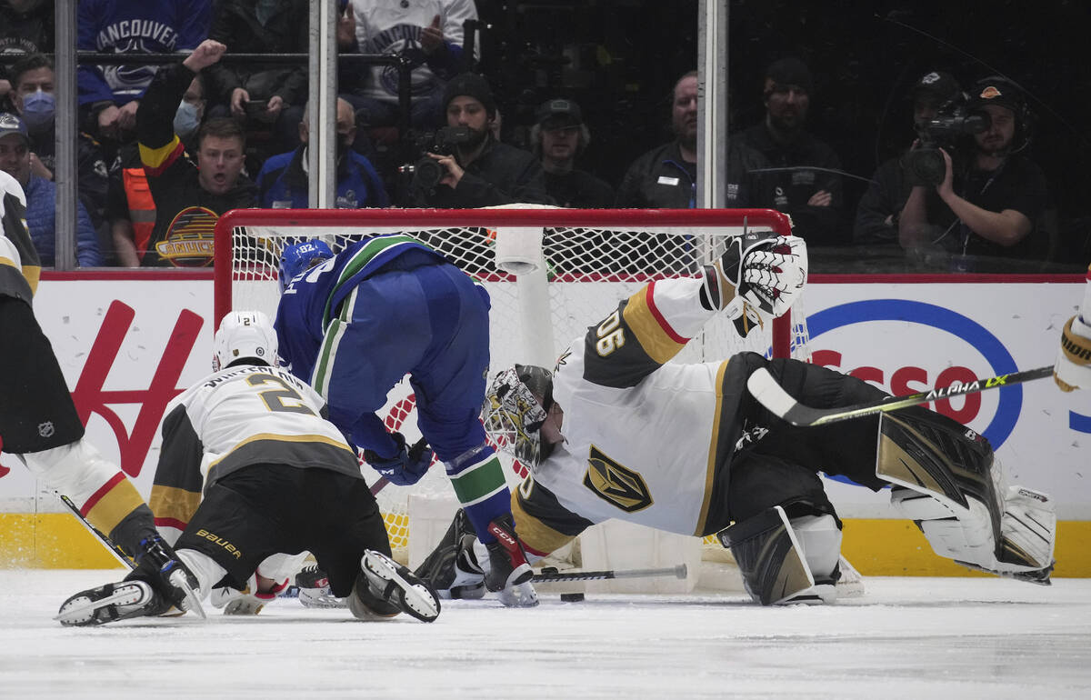 Vancouver Canucks' Vasily Podkolzin, second from left, scores against Vegas Golden Knights goal ...