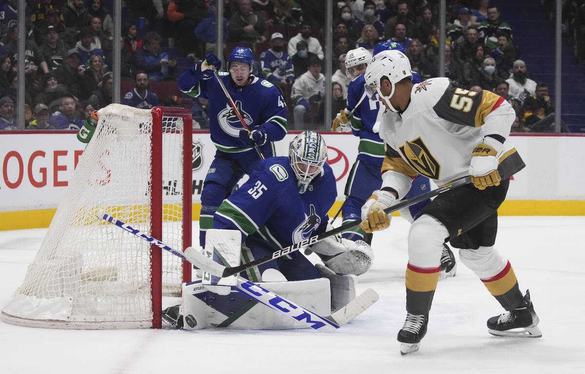 Vancouver Canucks goalie Thatcher Demko, left, stops Vegas Golden Knights' Keegan Kolesar durin ...