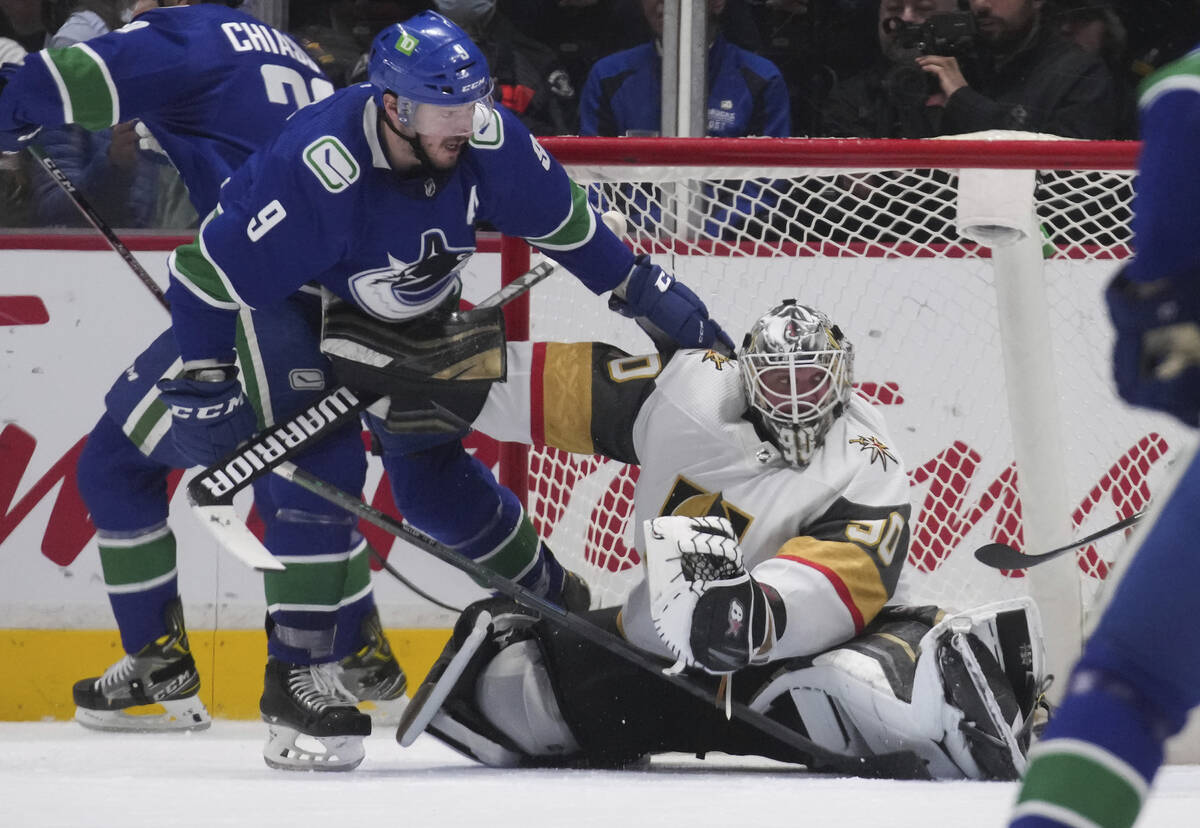 Vancouver Canucks' J.T. Miller, left, collides with Vegas Golden Knights goalie Robin Lehner du ...