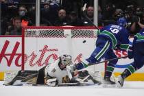 Vancouver Canucks' Quinn Hughes, right, scores against Vegas Golden Knights goalie Robin Lehner ...