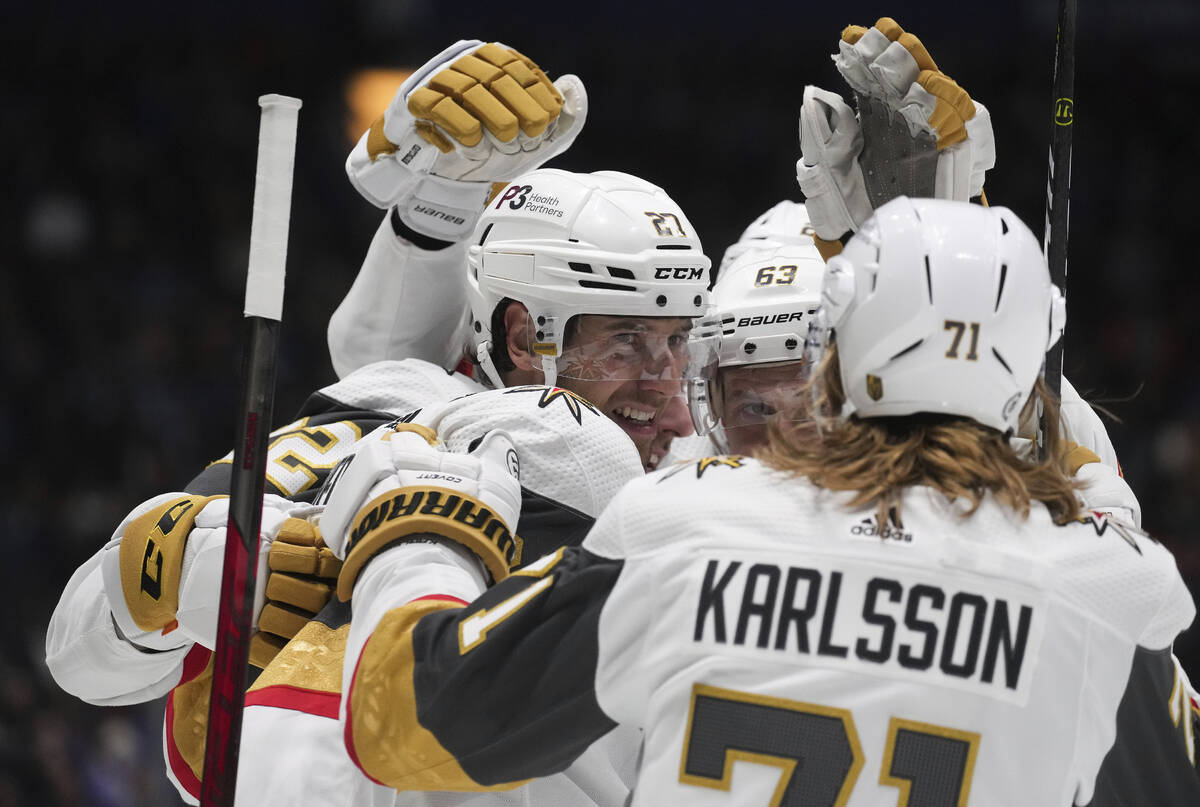 Vegas Golden Knights' Shea Theodore (27), Evgenii Dadonov (63) and William Karlsson (71) celebr ...