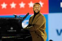 Performer John Legend plays the piano during a drive-in get out the vote rally featuring Democr ...