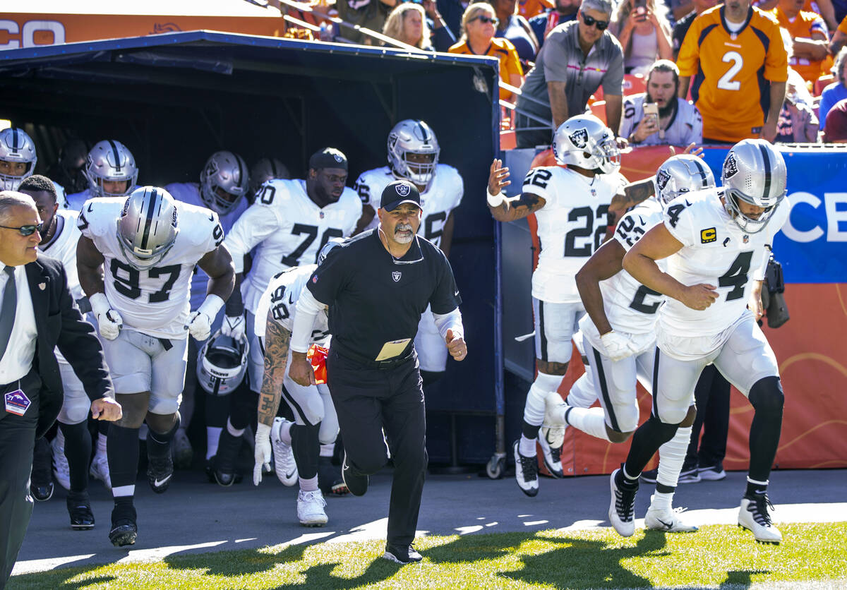 RaidersÕ interim head coach Rich Bisaccia runs onto the field with his players to face the ...