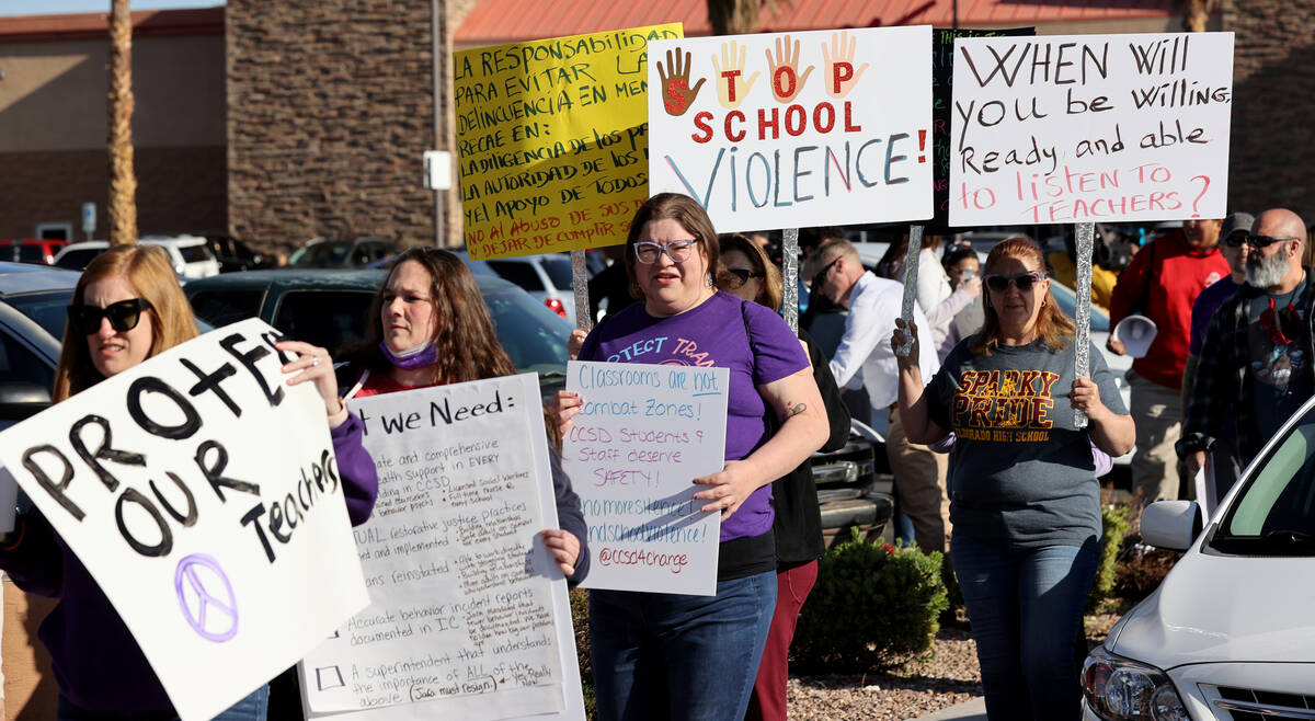 Parents, teachers and students protest violence in schools during a demonstration outside Clark ...