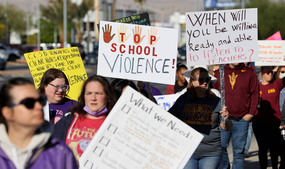 Parents, teachers and students protest violence in schools during a demonstration outside Clark ...