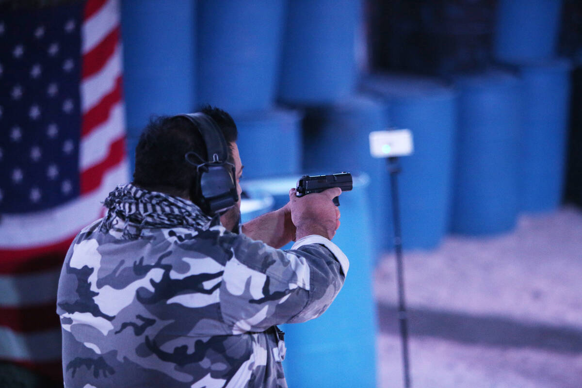 Nephi Oliva, owner of Las Vegas Gunfights, shoots a target to show how the FireFly indoor wirel ...