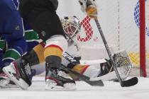 Vegas Golden Knights goalie Robin Lehner reaches to make the glove save against the Vancouver C ...
