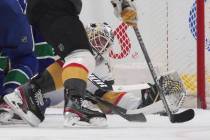 Vegas Golden Knights goalie Robin Lehner reaches to make the glove save against the Vancouver C ...