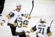 Vegas Golden Knights' Evgenii Dadonov, center, celebrates his goal with teammates Nicolas Roy, ...