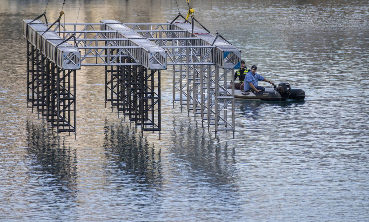 The first piece for the NFL Draft red carpet stage is lowered onto the water at the Bellagio Fo ...