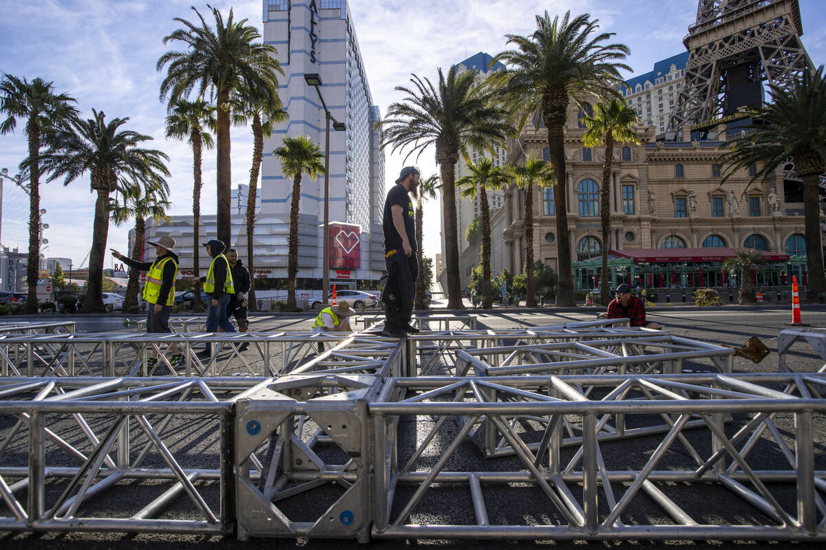 A construction crew assembles the second piece for the NFL Draft red carpet stage to be lowered ...