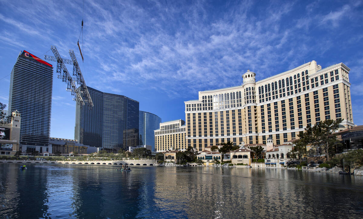 The second piece for the NFL Draft red carpet stage is lowered onto the water at the Bellagio F ...