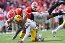 Missouri quarterback Tyler Macon (10) is sacked by Georgia's defensive lineman Travon Walker (4 ...