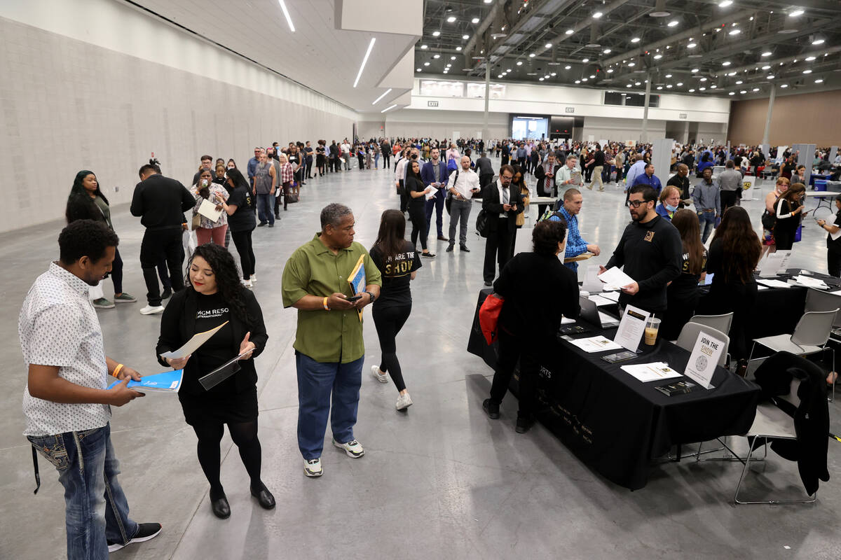 Marison Campos, a recruiter with MGM Resorts International, talks to Abebe Yimer of Las Vegas d ...