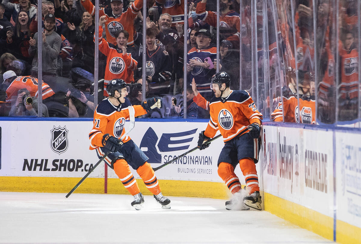 Edmonton Oilers' Ryan McLeod (71) and Warren Foegele (37) celebrate a goal against the Vegas Go ...