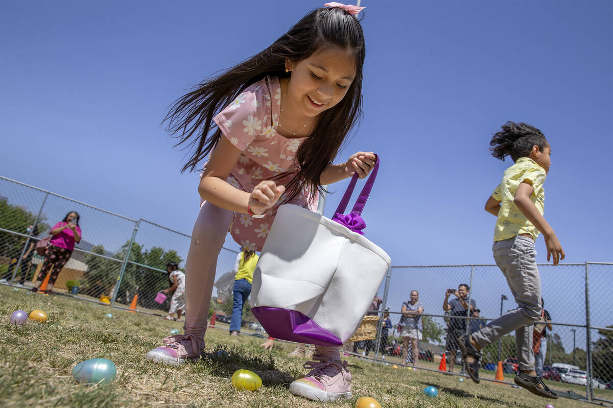 Zophie Serrano, 10, reaches for an egg during the Egg-Apalooza Easter egg hunt at the Paradise ...