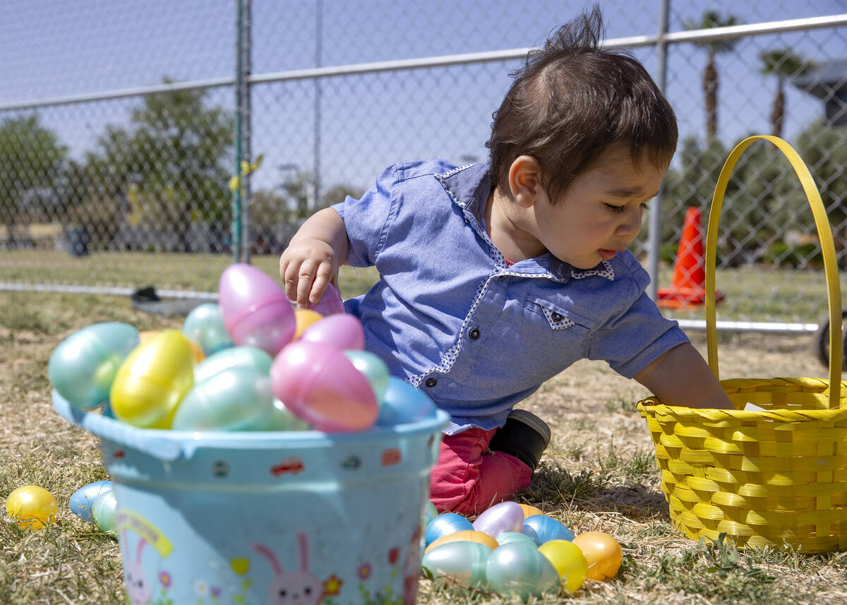 Dany Alubaidi, 1, opens his loot during the Egg-Apalooza Easter egg hunt at the Paradise Recrea ...