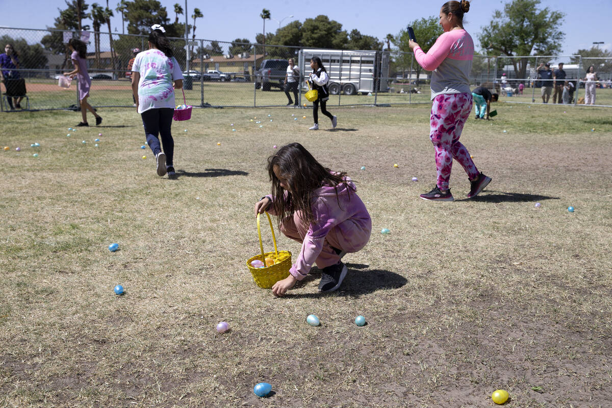 Children hunt for eggs during the Egg-Apalooza Easter egg hunt at the Paradise Recreational Cen ...