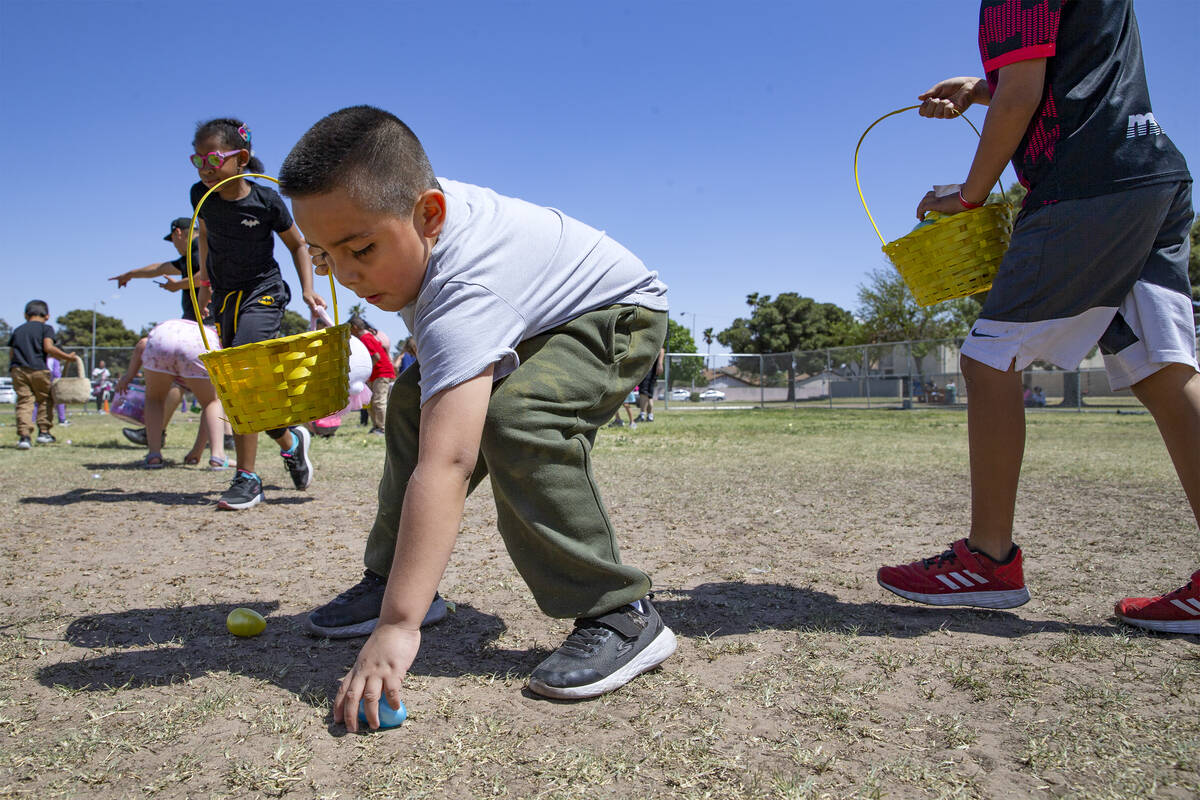 Dmitri Hernandez, 7, reaches for an egg during the Egg-Apalooza Easter egg hunt at the Paradise ...