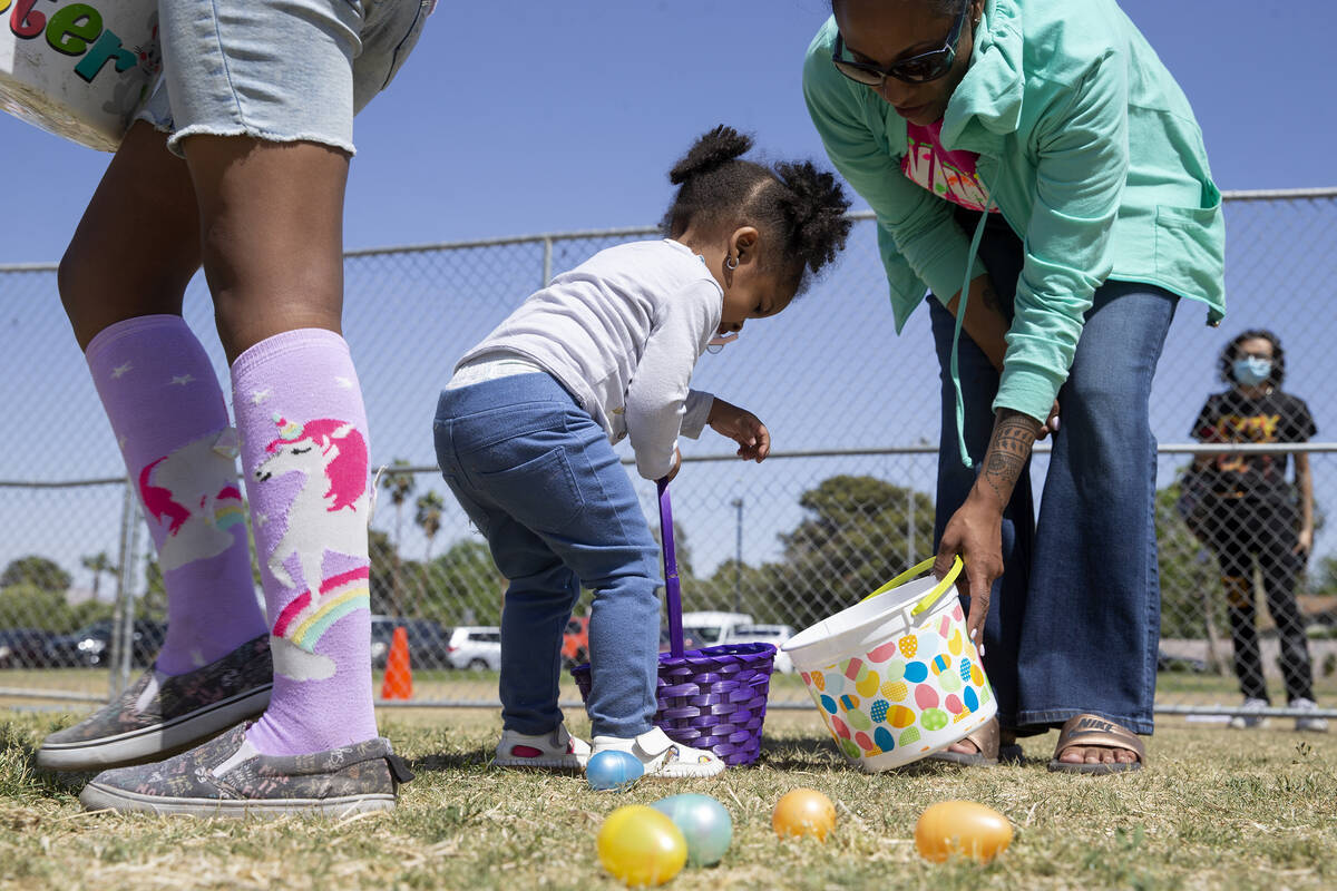 Jeanine Hall, right, helps her daughter Kieren Hall, 2, hunt for eggs during the Egg-Apalooza E ...