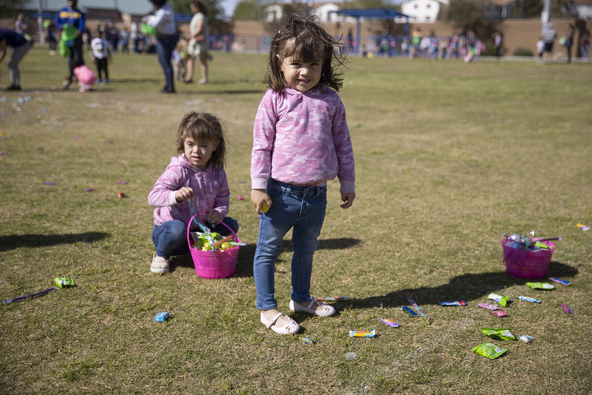 Julie Chavez, 5, left, and her sister Estela, 3, participate during the Hoppy Egg Run community ...