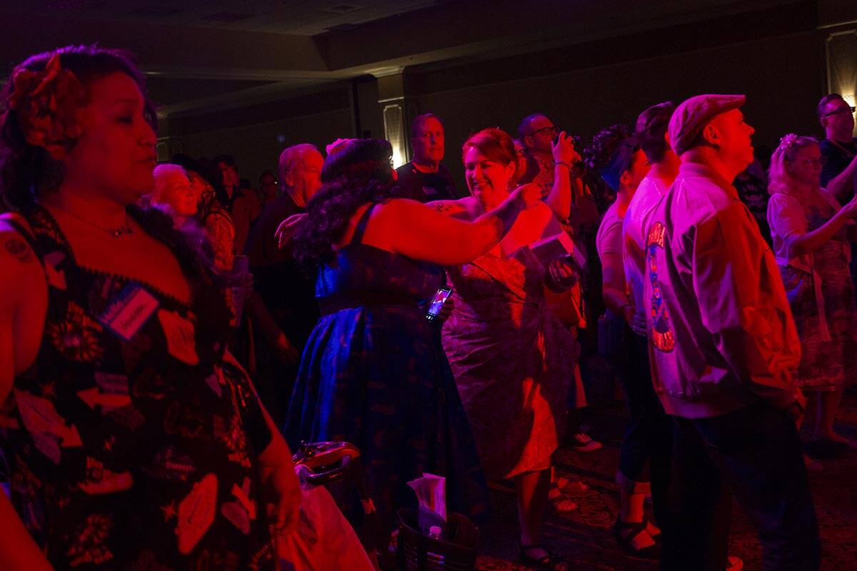 Audience members embrace as the Shanda Howlers play their set during Viva Las Vegas Rockabilly ...