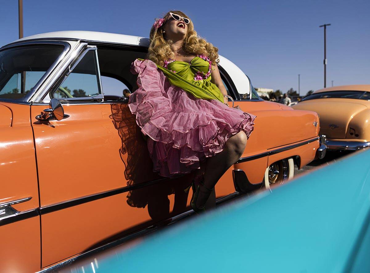 Jody Collins, from Sacramento, Calif., takes photos with a classic car during the Rockabilly Ca ...