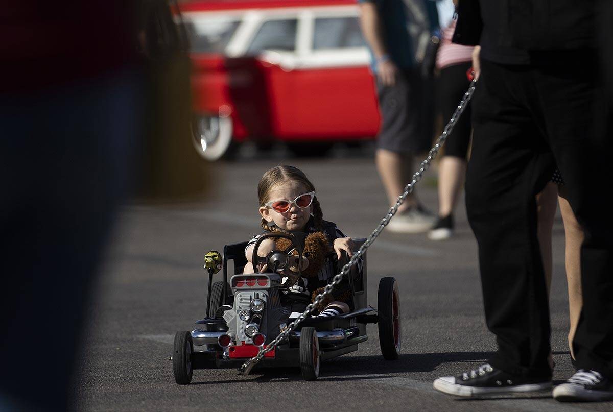 Enrique Vega, from Los Angeles, Calif., is pulled in her miniature hot rod during the Rockabill ...