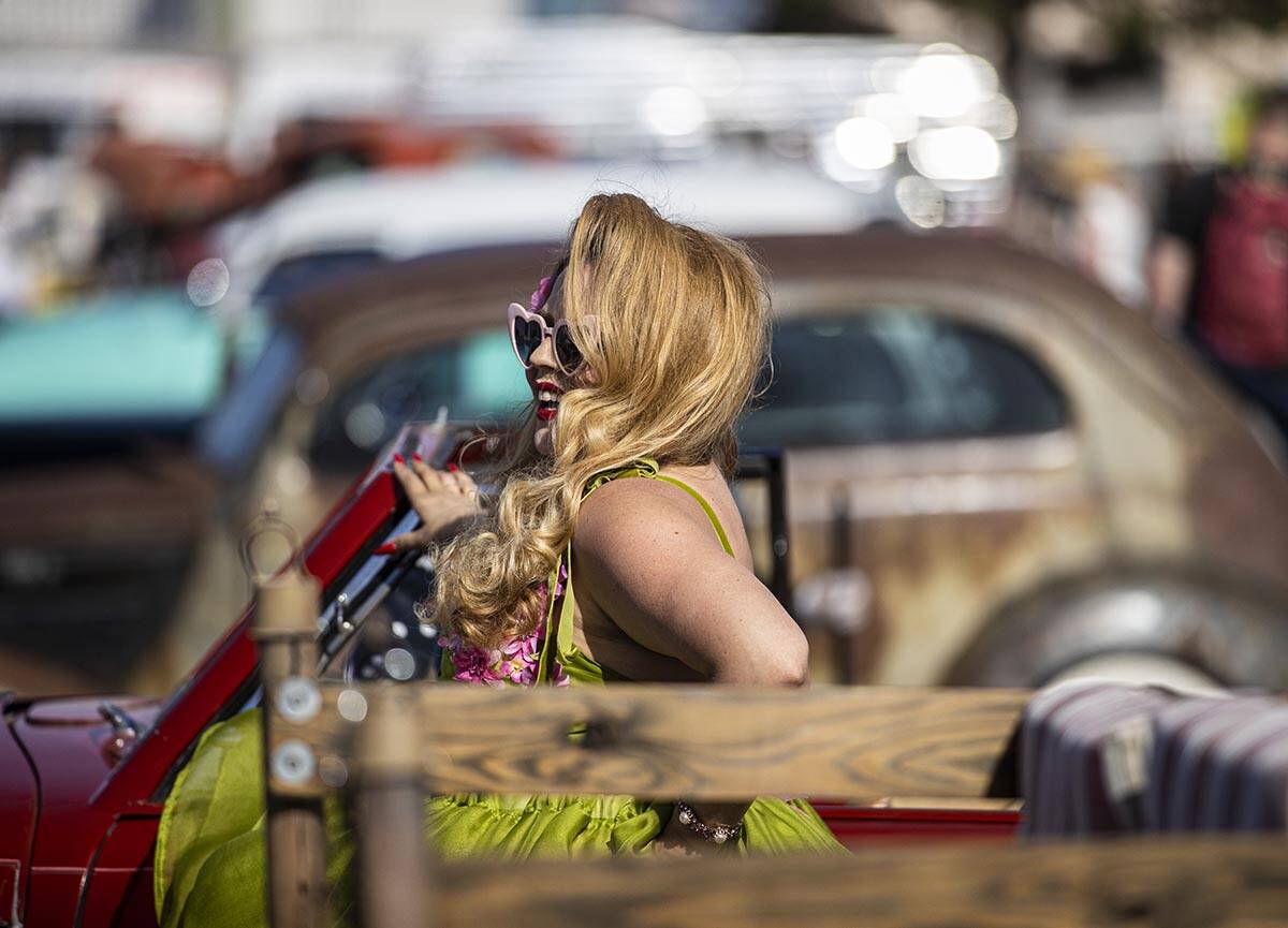 Jody Collins, from Sacramento, Calif., takes pictures with classic cars during the Rockabilly C ...