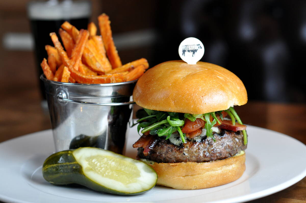 A Gold Standard burger from Holsteins Shakes and Buns in The Cosmopolitan is dressed with aged ...
