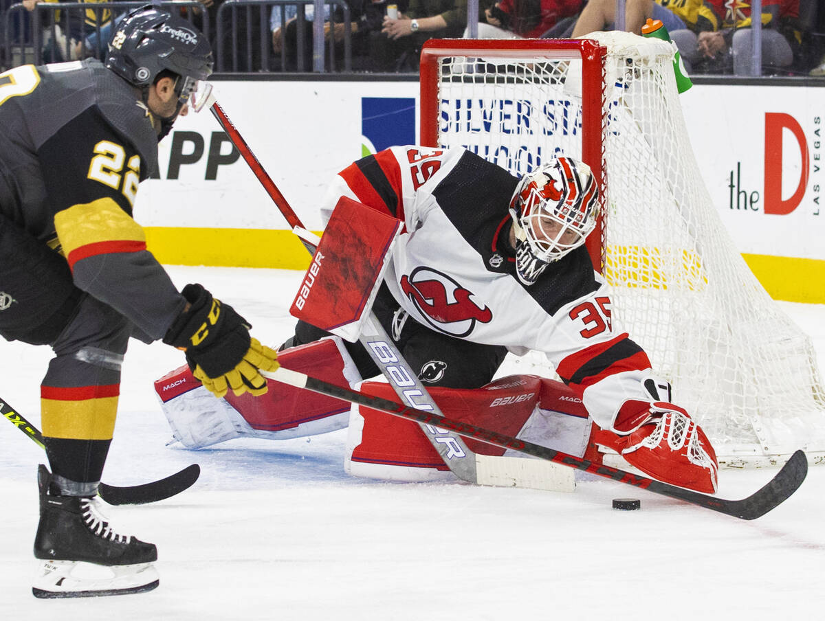 Golden Knights center Michael Amadio (22) shoots on New Jersey Devils goaltender Andrew Hammond ...