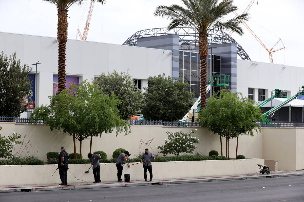 Workers clean walls at the NFL Draft Experience under construction behind The Linq Hotel in Las ...